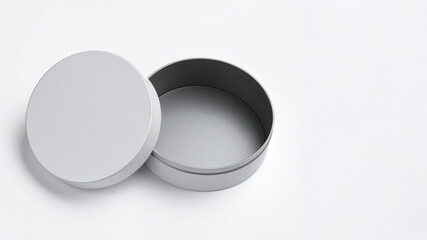 A simple, open round tin container with a slightly detached lid. Clean and versatile for showcasing product packaging, storage solutions, or minimalist design concepts.