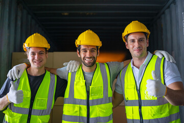 Blue collar workers are working at warehouse.