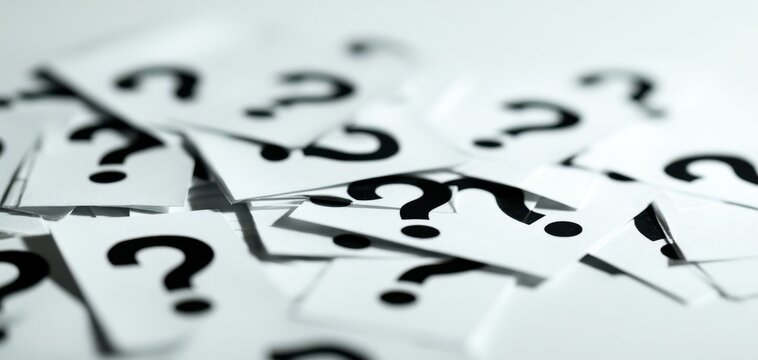 The question marks scattered on a white background evoke curiosity and uncertainty.