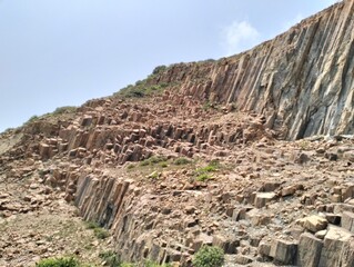 Columnar Basalt Rock Formations with Vertical Cracks and Unique Natural Patterns