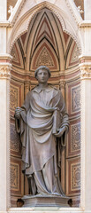 FLORENCE, ITALY - MARCH 17, 2025: The bronze statue St. Stephen on the facade of Orsanmichele by...