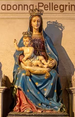 Fototapete Rund ASTI, ITALY - SEPTEMBER 10, 2024:  The carved polychrome statue of Madonna (Madonna del Portone) in the church Santuario di Nostra Signora Porta Paradisi from 19. cent.  © Renáta Sedmáková