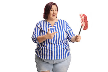 Corpulent woman pointing at a raw steak