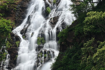 Fototapeta premium Namtok Sarika is the most famous waterfall in Nakhon Nayok , The nine-tiered waterfall cascading down the cliff to a forested hillside has a large natural pool on each level . THAILAND 
