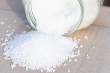 Urea granules (carbamide, CO(NH2)2) in glass jar.  Nitrogenous mineral fertilizer for plant...