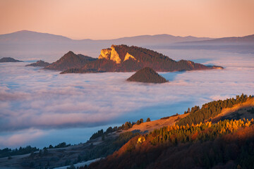 Mountain Peaks Above Clouds at Sunrise