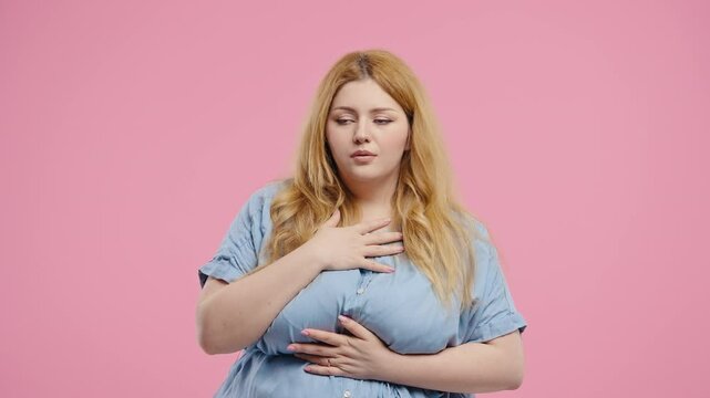 Curvy woman reacts with visible fear, startled while looking directly at camera