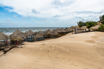 Colorful waters and natural-framed kiosks at Pesqueiro Beach, Soure in Marajo Island, Brazil