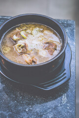 Beef Short Ribs Soup served in a stone bowl on a table
