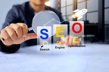 SEO concept with businessman using magnifying glass to find important strategies increase the...