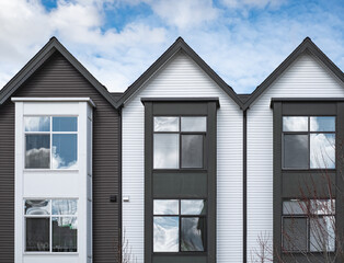Real Estate Exterior Front townhomes. Facade of a row of modern urban townhouses