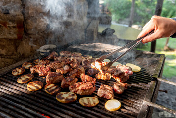 Chicken, pork meat and vegetables cooked on rostil grill, traditional meat dish