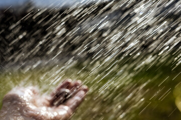 Hand reaching up in the water flow, capturing a serene moment of nature's beauty. A person's hand...