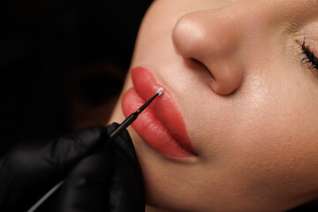 Macro of perfectly contoured pink lips with natural tone and smooth, healthy surrounding skin.