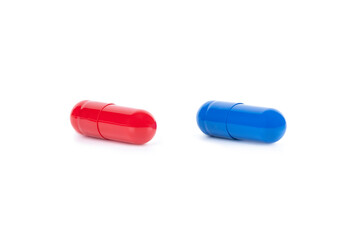A red pill and a blue pill side by side, representing a difficult choice. A concept for a major...