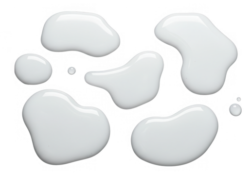 Several opaque white milk drops and puddles are isolated on transparent background