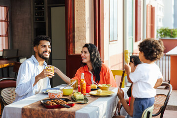 Latino family enjoying an outdoor meal and sharing joyful moments together
