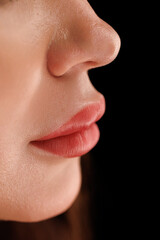 Obraz premium Rich pink lips with precise contouring and clear skin, captured in soft lighting.