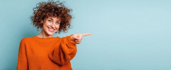The cheerful woman in an orange sweater pointing towards the future.
