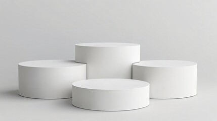 Set of white circular display platforms on neutral background for cosmetic or product mockup presentations
