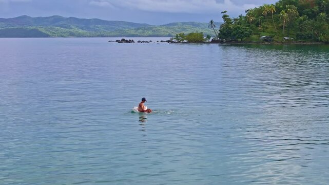 Man fishing alone on water using sack float, calm mood, Dinagat Islands, Philippines