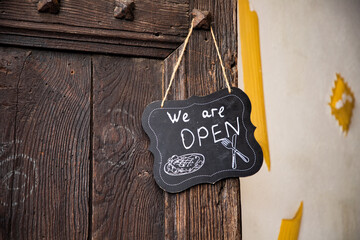 we are open sign on restaurant door