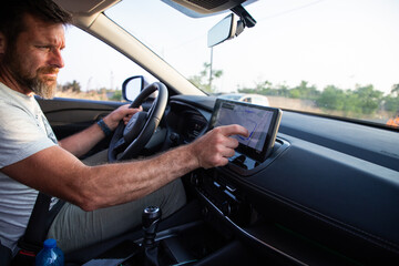 man driving a car at sunset