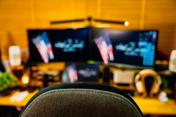 Modern home office desk setup with American Independence Day theme, including monitors displaying...