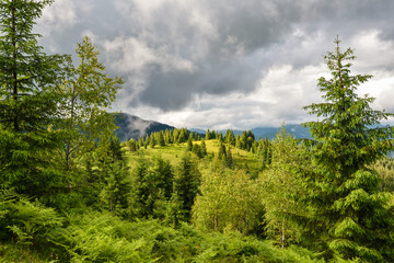 Wonderful summer panorama with mountains. A thunderstorm is coming. Rain Clouds Above Mountains. Location place Carpathian mountains, Ukraine, Europe.