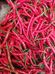 Close-up of numerous vibrant red chili peppers.