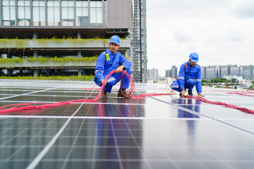 Electrical engineers are inspecting and installing a solar panels on the building rooftop.