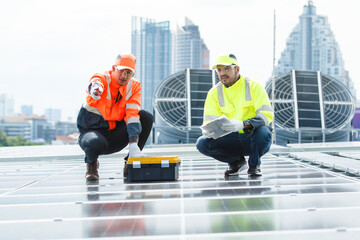 Electrical engineers are inspecting and installing a solar panels on the building rooftop.
