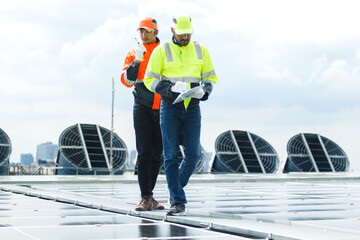 Electrical engineers are inspecting and installing a solar panels on the building rooftop.