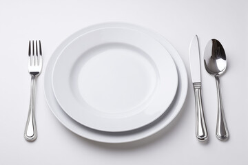 Selective focus white dish with spoon, fork and knife isolated on white background, Luxury fine dining dish with silverware on white background.