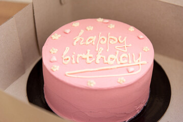 Pink house made cake with inscription message for birthday girl three years old