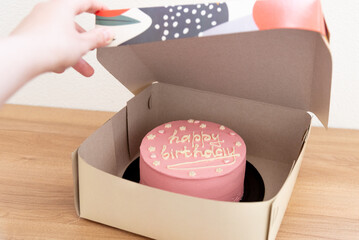 Pink house made cake with inscription message for birthday girl three years old