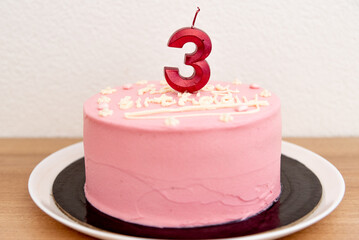 Pink house made cake with inscription message for birthday girl three years old