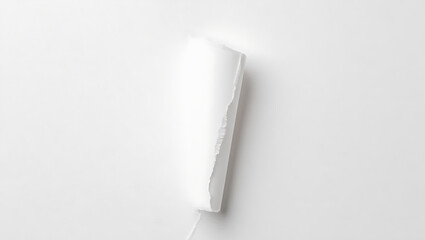 A vertical tear in white paper reveals a bright light source behind the material