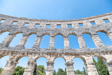 Visitors admire the ancient Roman amphitheatre in Pula, Istria Peninsula, showcasing its impressive...