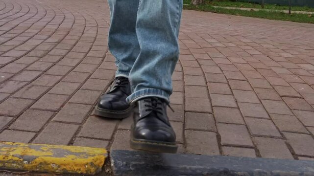 legs crossing road on yellow crosswalk