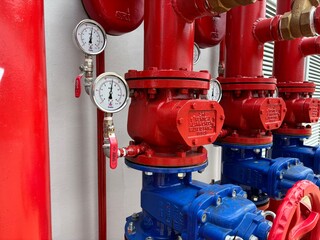 red fire hydrant. Bright red industrial fire pump system, used in emergency response within...