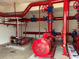red fire hydrant. Bright red industrial fire pump system, used in emergency response within...