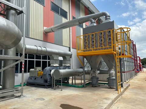 Industrial dust collector system and blower fans installed outside factory for air filtration and ventilation efficiency