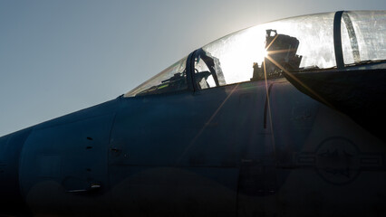 Military airplane cockpit with sunburst