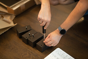 The man handyman is engaged in assembling the cupboard.
