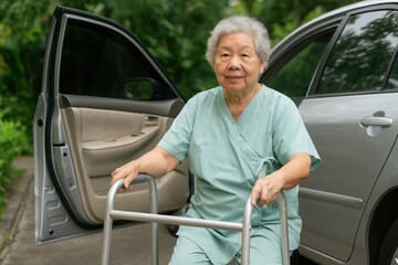 Elderly woman with walker, Senior Asian woman in light green scrubs uses walker while exiting car outdoors. Standing on sidewalk near vehicle. Aging mobility and independence concept