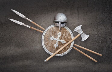 viking helmet axe shield and two spears on grunge background
