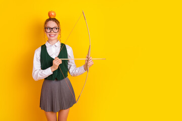 Teenager in school uniform with bow and apple on yellow background showcasing creativity and...