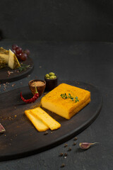 Several types of cottage cheese and cream cheese with spices among vegetables, herbs and fruits