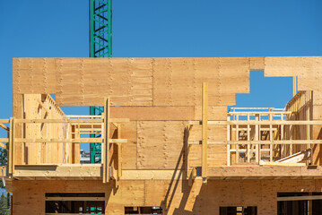 Modern apartment building under construction. The site with crane in Vancouver, Canada, North...